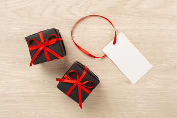 Black gift boxes on wooden background, top view. Black Friday concept