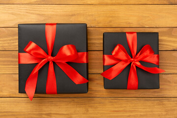 Black gift boxes on wooden background, top view. Black Friday concept
