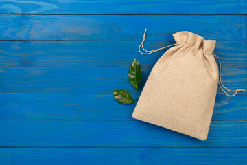 Small eco sack on wooden background, top view
