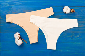 Set of woman panties on wooden background, top view