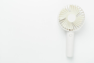 Mini electric fan on color background, top view