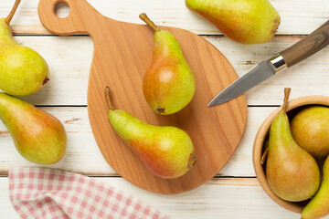 Fresh red and green pears on wooden background,top view
