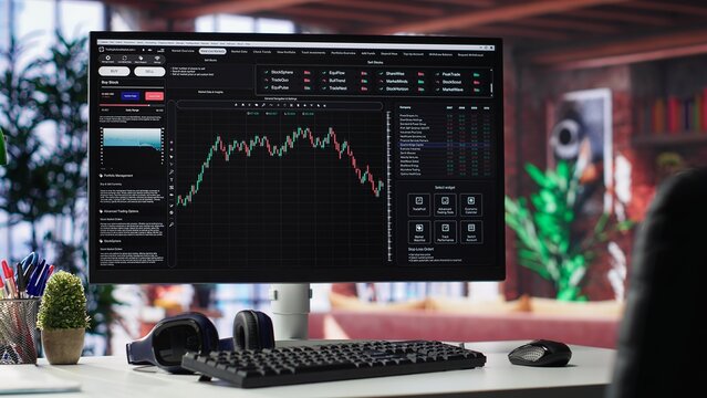 Empty workspace desktop running day trading stock market trends in stylish apartment. PC used for monitoring investment numbers and candle stick charts, a comfortable environment.