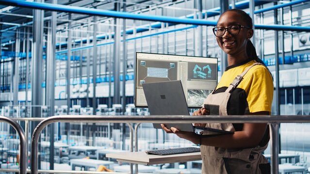 Portrait of happy engineer in smart photovoltaics factory looking at system performance metrics. Cheerful worker in solar panels plant tracking energy production through IoT sensors, camera A - Powered by Adobe
