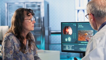 Physician consulting a patient about an MRI scan providing diagnostics insights into tumor growth...