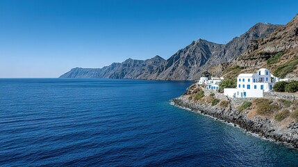 Coastal scene with white buildings clinging to a rocky shoreline.