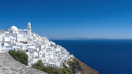 Whitewashed village perched on a cliff overlooking the sea.