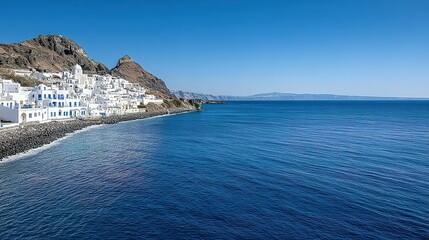 Coastal town with white buildings and blue sea.