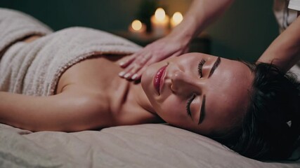 Portrait of young woman at spa in dark light with candles and lights , massage and relax concept - Powered by Adobe