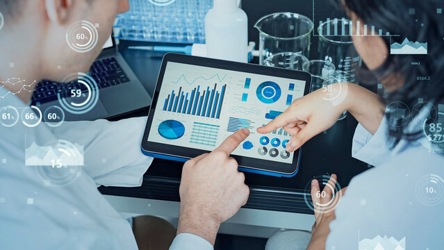 Researcher studying while looking at a tablet and statistical data concept
