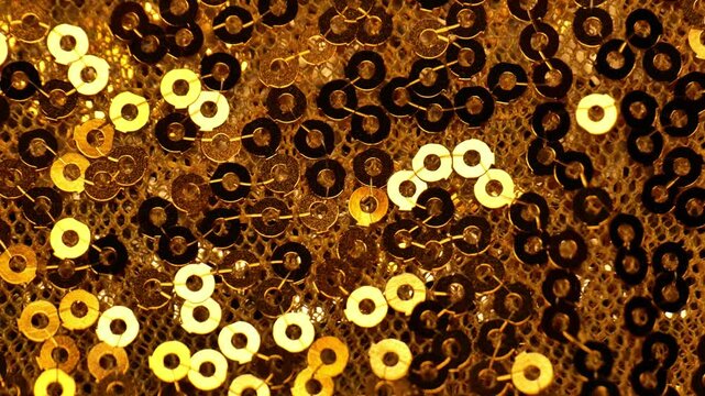 sequins wallpaper in a black and gold tones.Scales background.New Year and Christmas Festive background. 4k footage