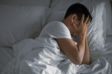 Sleepless man in bed feeling helpless, tired, depressed emotional feeling, insomnia 