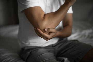 Man with elbow injury, pain relief concept concept muscle pain due to lateral epicondylitis or tennis elbow injury, Health care concept	