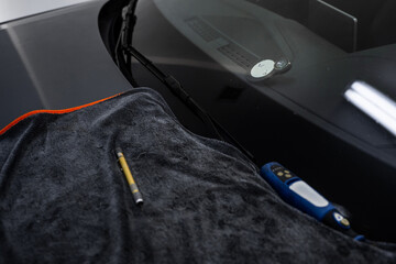 Visible spider cracks in the windshield are highlighted with a targeting lens. The marked chip is...