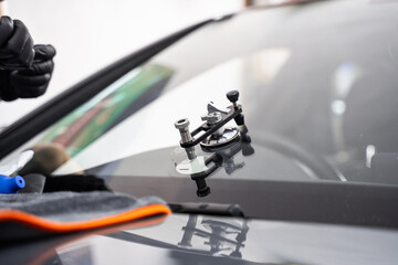 Mounted windshield repair bridge holds resin applicators securely over the crack. Bridge tool for...
