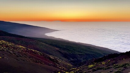 Marvelous and stunning sunset casting vibrant colors over a picturesque coastal mountain landscape
