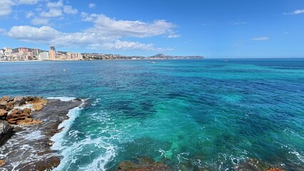 Enjoy the stunning coastal view of turquoise waters and a magnificent city skyline