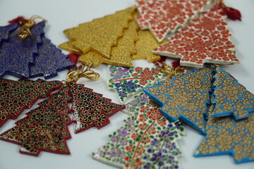 Hand-painted papier-mâché Christmas goodies by Kaar Kash, featuring stars, bells, trees, and more—crafted for hanging on Christmas trees and adding artisanal charm to festive décor.


