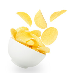 Tasty crispy potato chips falling into bowl on white background