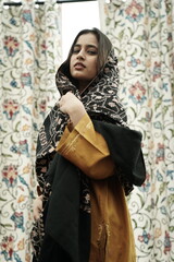 Kashmiri girl posing wearing pheran and shawl