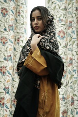 Kashmiri girl posing wearing pheran and shawl