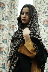 Kashmiri girl posing wearing pheran and shawl