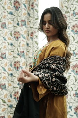 Kashmiri girl posing wearing pheran and shawl