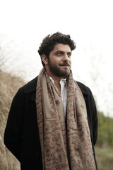 A Kashmiri model dressed in a traditional shawl and vintage-style pheran, posing for a Kaar Kash...