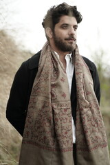 A Kashmiri model dressed in a traditional shawl and vintage-style pheran, posing for a Kaar Kash...