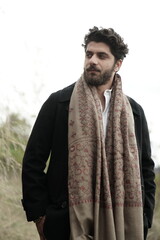 A Kashmiri model dressed in a traditional shawl and vintage-style pheran, posing for a Kaar Kash...