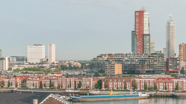 Panoramic aerial timelapse of Katendrecht peninsula and Maashaven harbour in Rotterdam, The Netherlands. City skyline at morning, modern skyscrapers and former factory with Dutch waterfront houses
