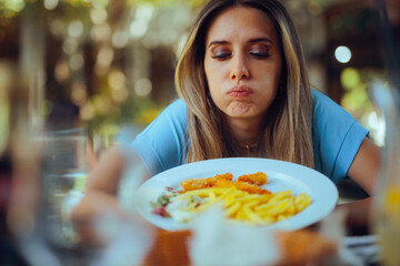 Picky Eating Customer Feeling Unhappy with restaurant Dish. Capricious woman dinning out being dissatisfied with her meal
