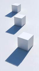 Obraz premium Minimalist design featuring three cubes casting long shadows on a white surface in a studio setup