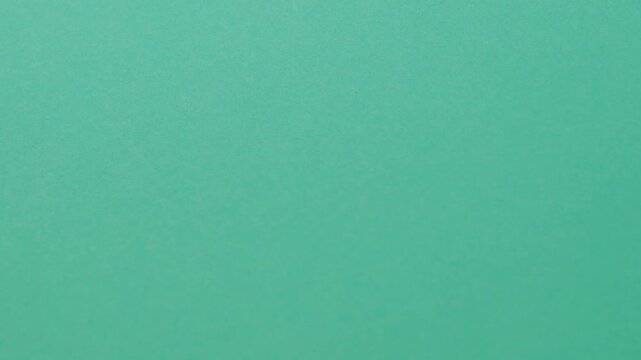 Close-up of colorful construction paper texture with soft, fluctuating shadows creating a subtle, dynamic background loop.