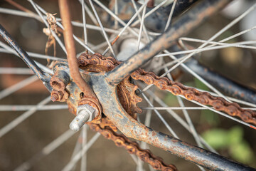 Close up of old rusty bicycle rear wheel and chain, selective focus