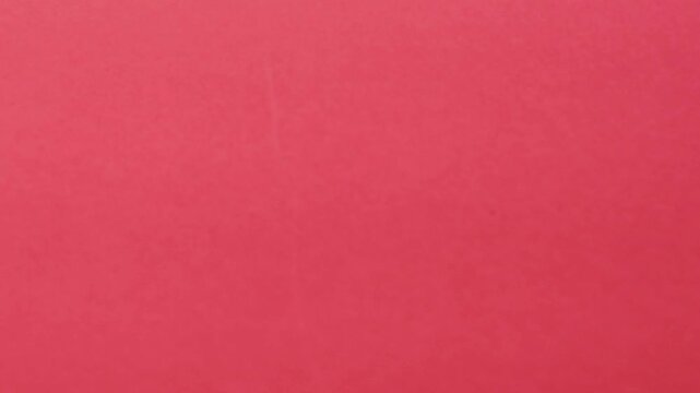 Close-up of colorful construction paper texture with soft, fluctuating shadows creating a subtle, dynamic background loop.