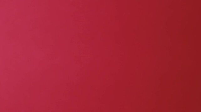 Close-up of colorful construction paper texture with soft, fluctuating shadows creating a subtle, dynamic background loop.