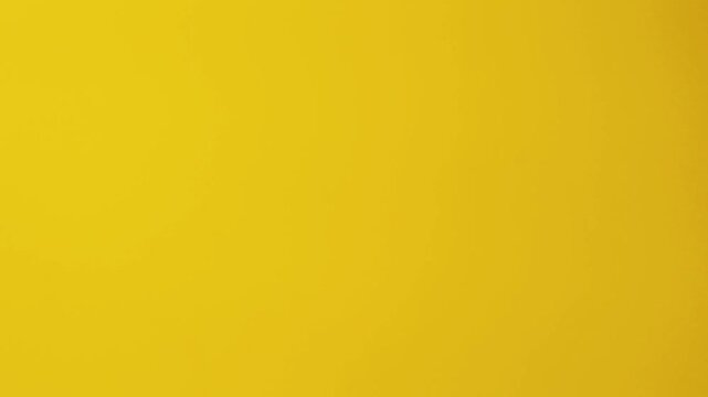 Close-up of colorful construction paper texture with soft, fluctuating shadows creating a subtle, dynamic background loop.
