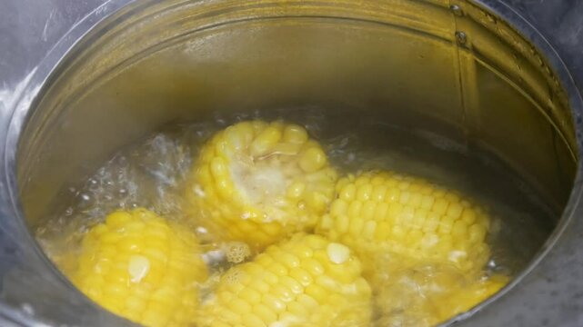 boil corn in a concave pan with boiling hot water