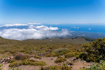 Maui's landscape from above the clouds, showing the island's diverse terrain and the vast Pacific...