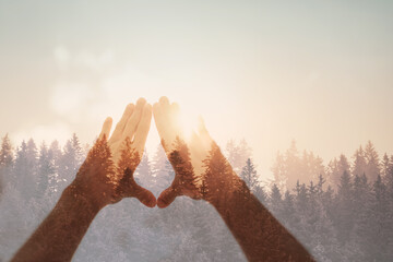 Woman hands holding the sun at dawn. Freedom and spirituality concept. 