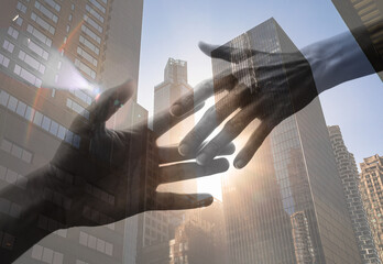 Hand reaching out to help a friend in need on city background, unity, trust concept 