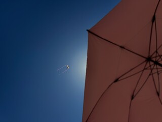 Kite in the sky with beach unbrella