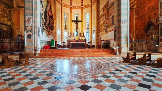 Interior of Basilica di San Zeno Maggiore frames tall columns and luminous clerestory windows above the central aisle, Verona, Veneto, Italy