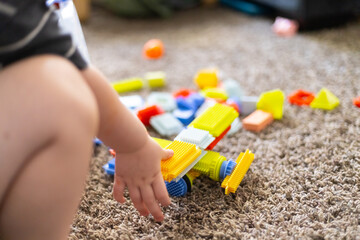 Toddler’s Hands Playing with Bristle Blocks