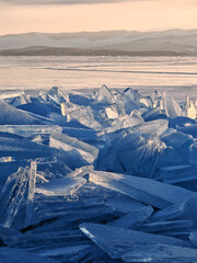 Endless hummock field on frozen Lake Baikal. Piles of snow-covered debris of blue ice on frosty day