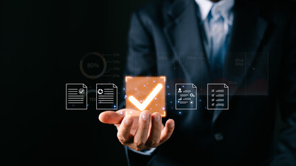 A businessman professional holds a glowing digital certificate document icons, a large checkmark symbolizing digital approve processes, focusing on business quality assurance and data management.