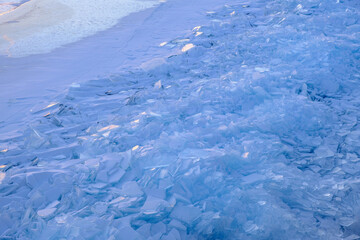 Endless hummock field on frozen Lake Baikal. Piles of snow-covered debris of blue ice on frosty day