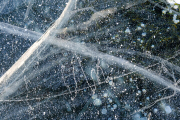 Beautiful ice of Lake Baikal with abstract cracks