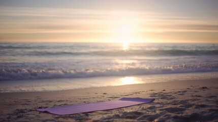 Fototapeta premium Tranquil beach sunset with gentle waves rolling towards the shore, creating soft white froth as they meet the sandy beach. The sun casts a warm golden-orange hue across the sky, reflecting beautifully